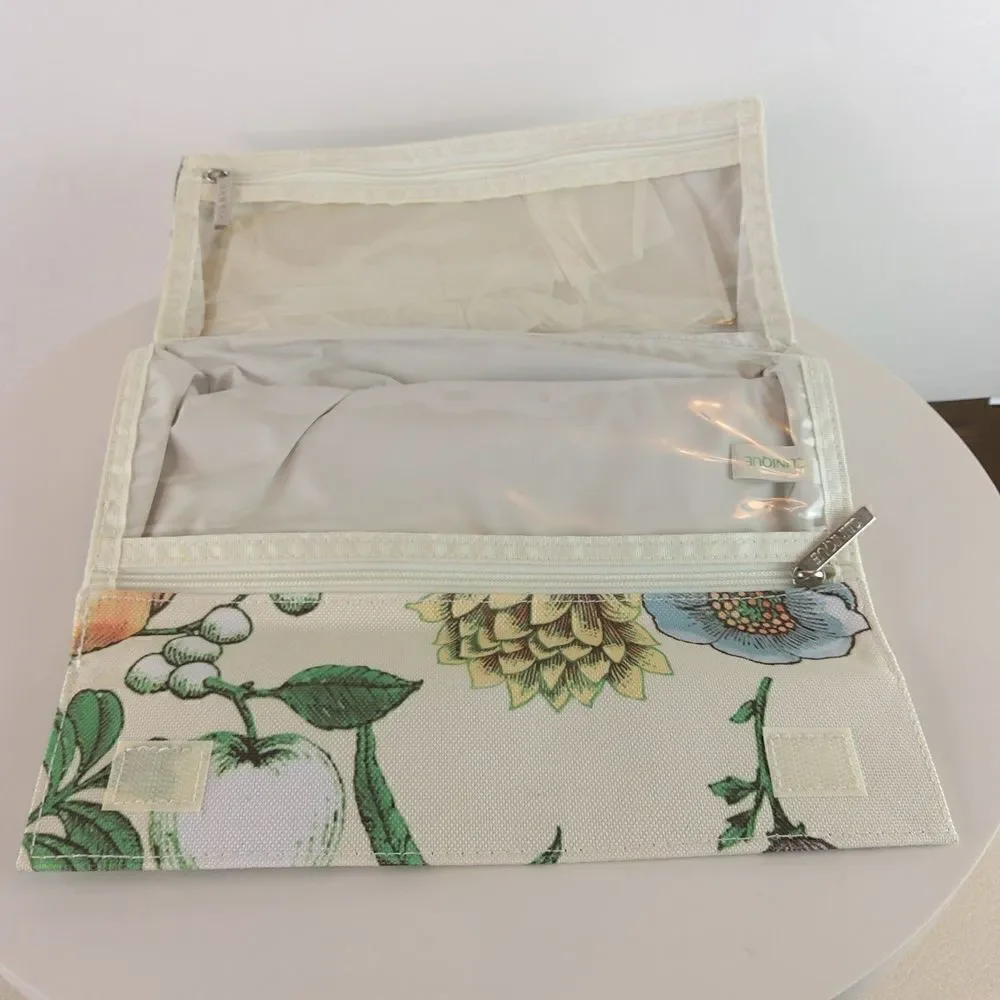 Clinique cream floral print fold over makeup / jewelry bag.